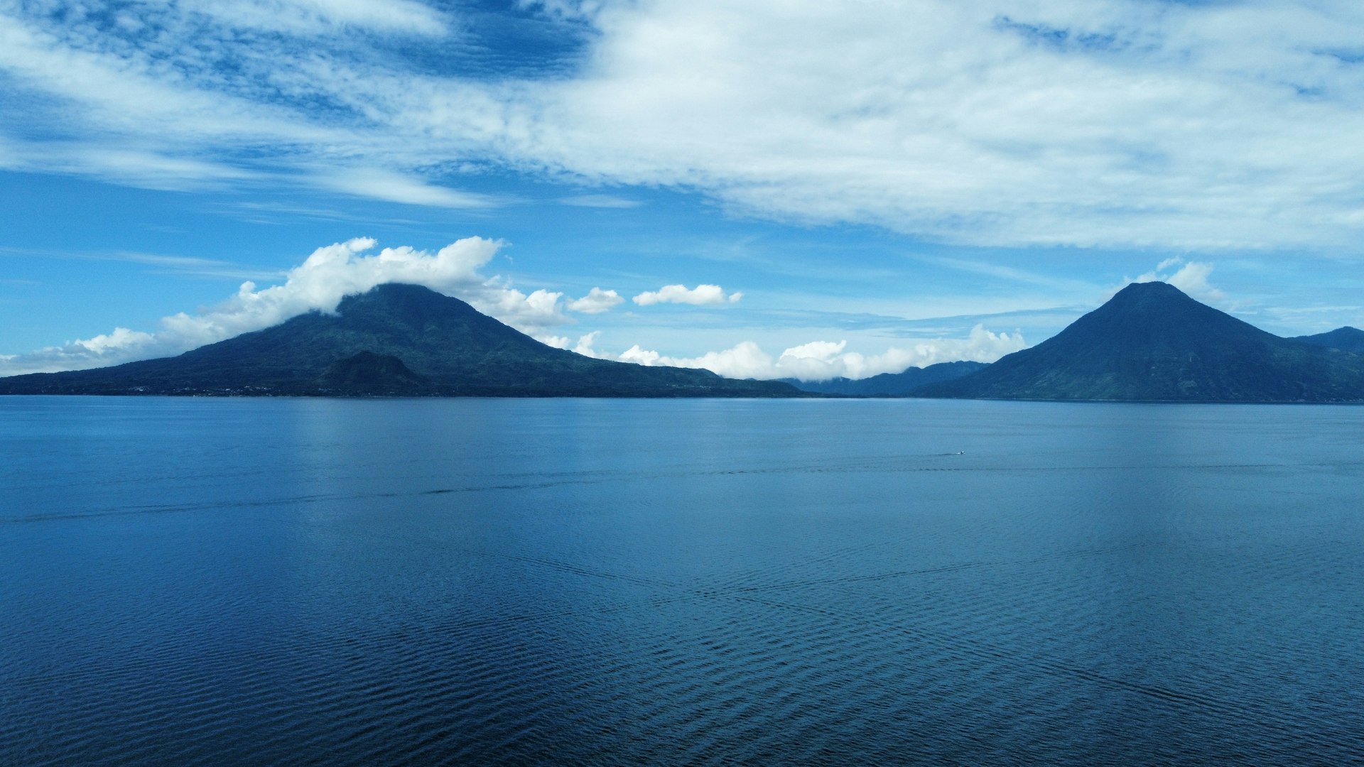 Lake Atitlán at dusk with volcanoes